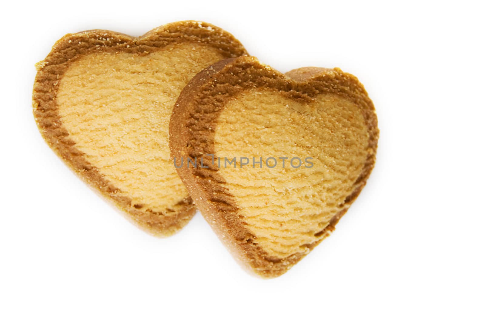 Two heart shaped biscuits over white