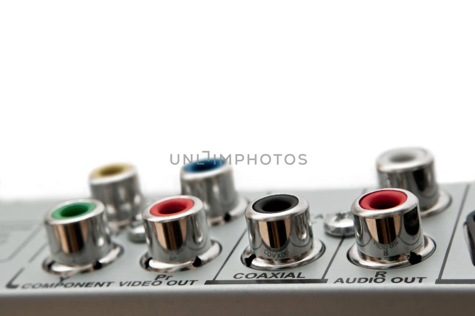 Close up capturing audio visual sockets on the rear of an electrical device. White background.