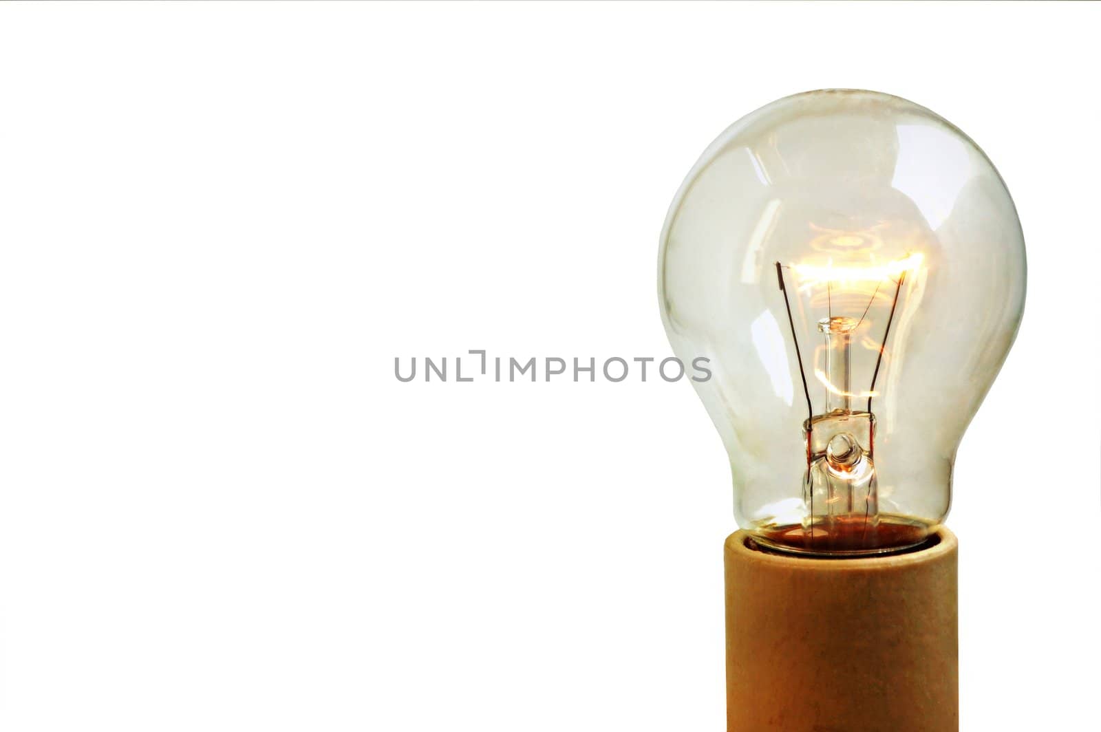 An old light bulb on, isolated on white background and on a socket