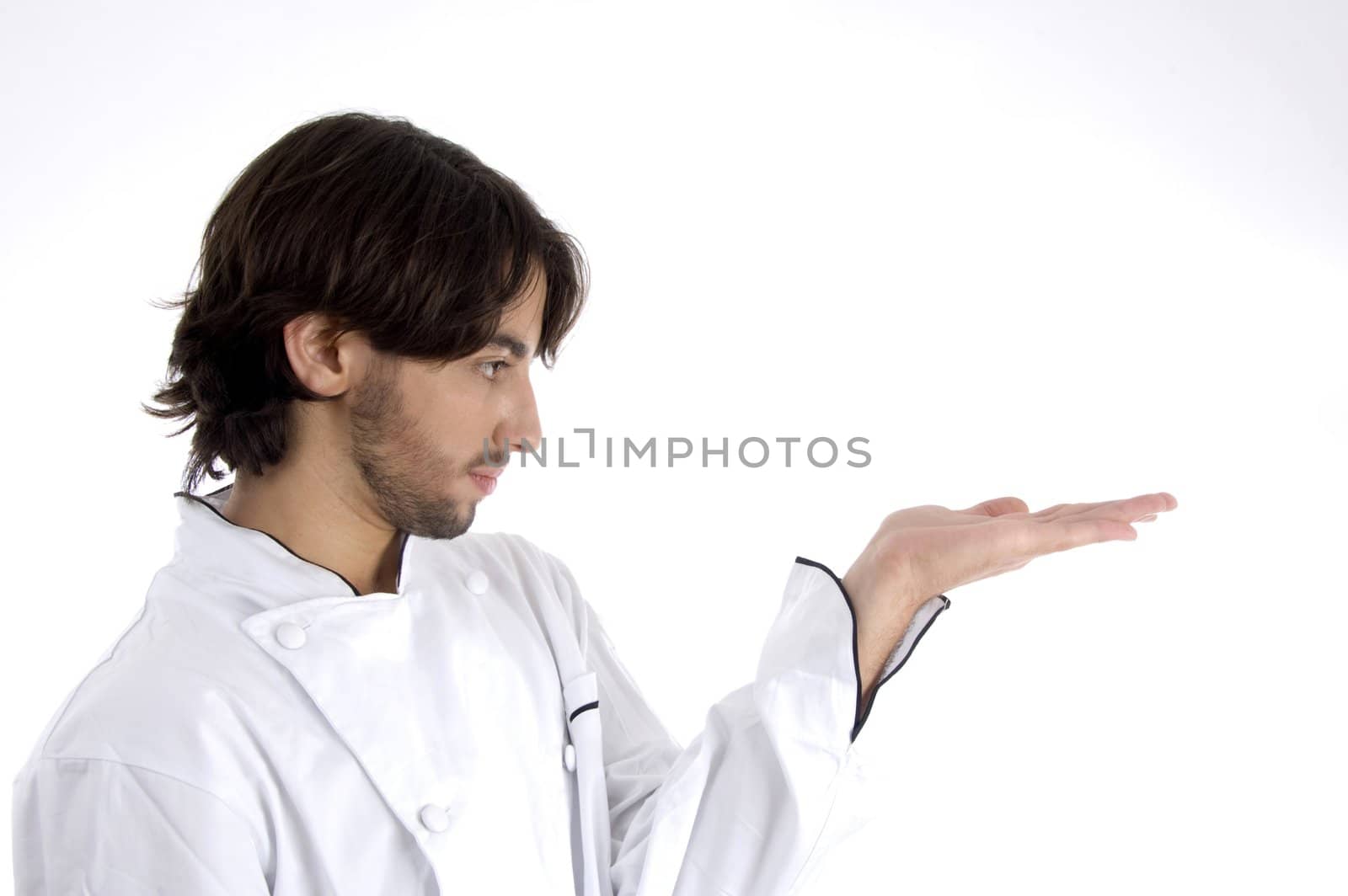 young chef looking his palm on an isolated background