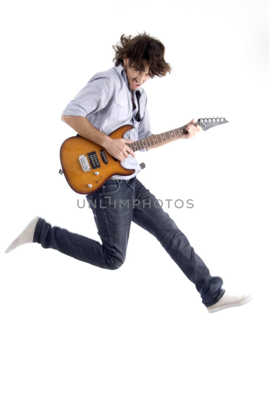 jumping young male with guitar with white background