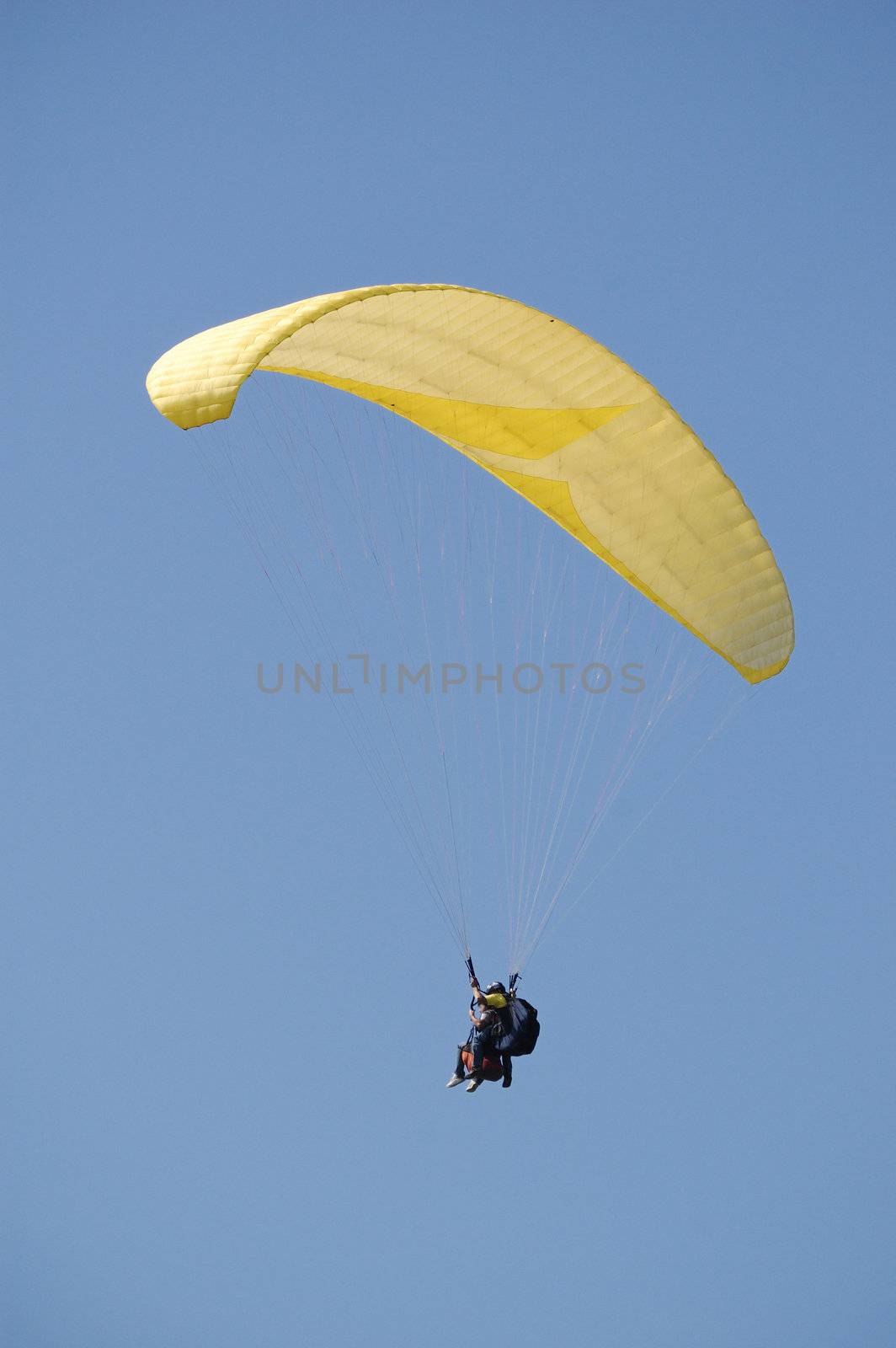 Double Paragliding flying throught the sky above the ocean
