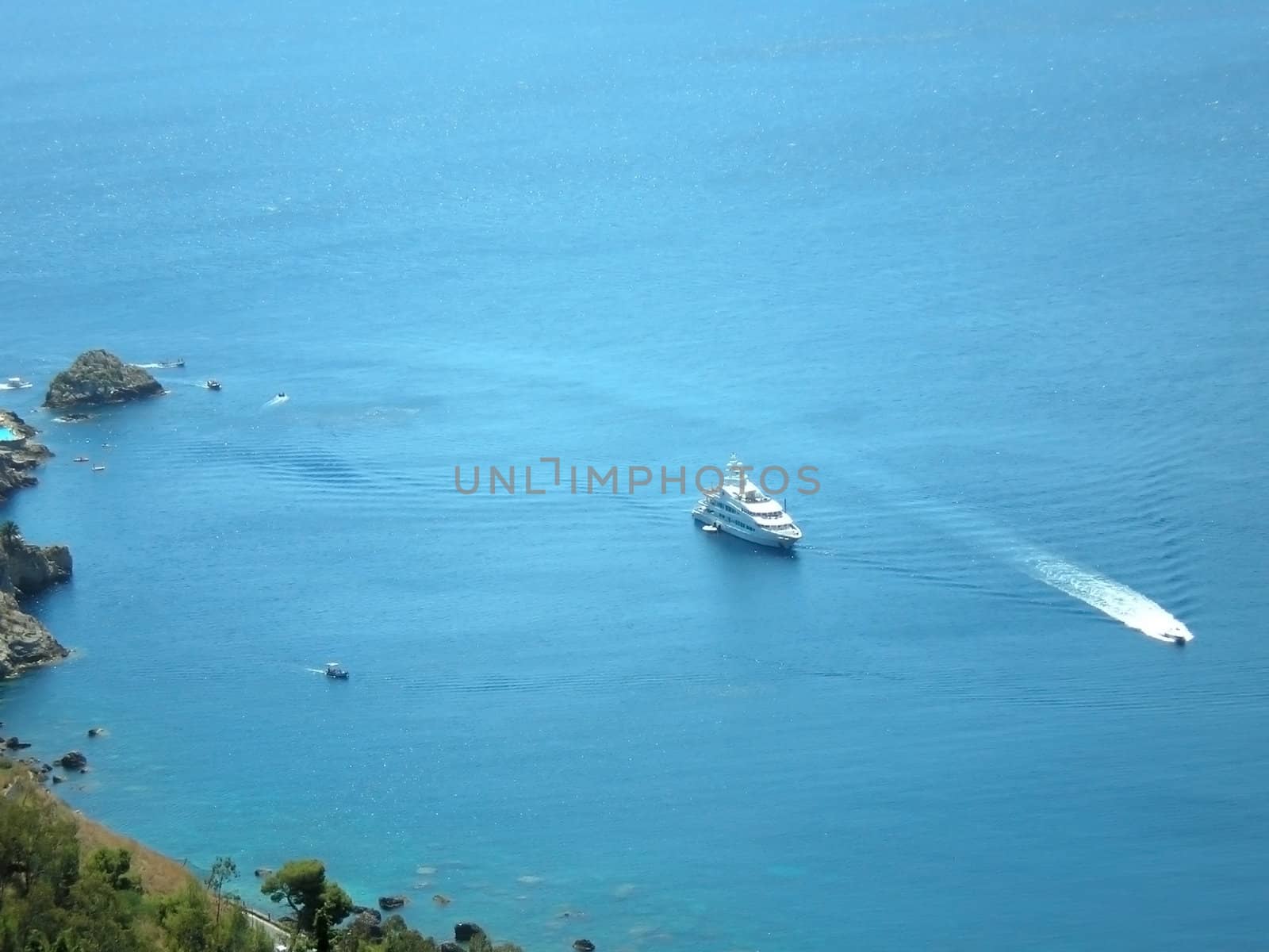 a yacht in front of taormina  