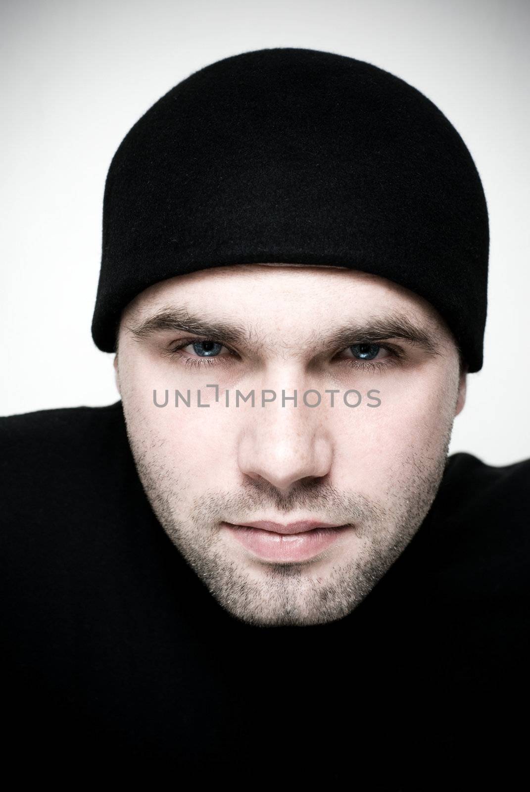 Intense portrait of young man - selective focus on the model's eyes.