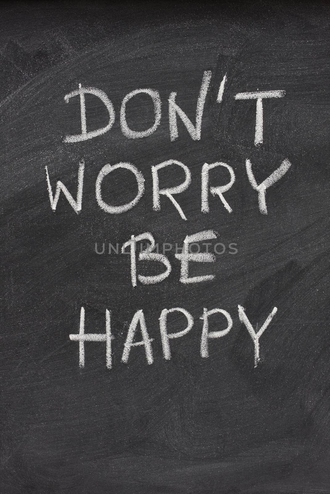 don't worry be happy phrase on blackboard by PixelsAway