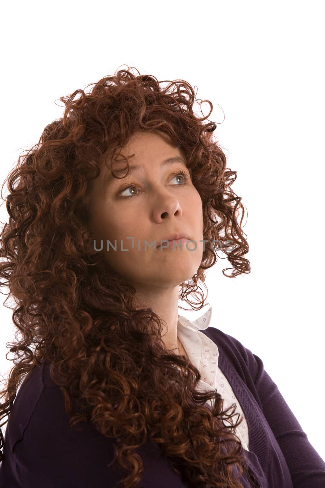 Woman with long red curly looking looking thoughtful