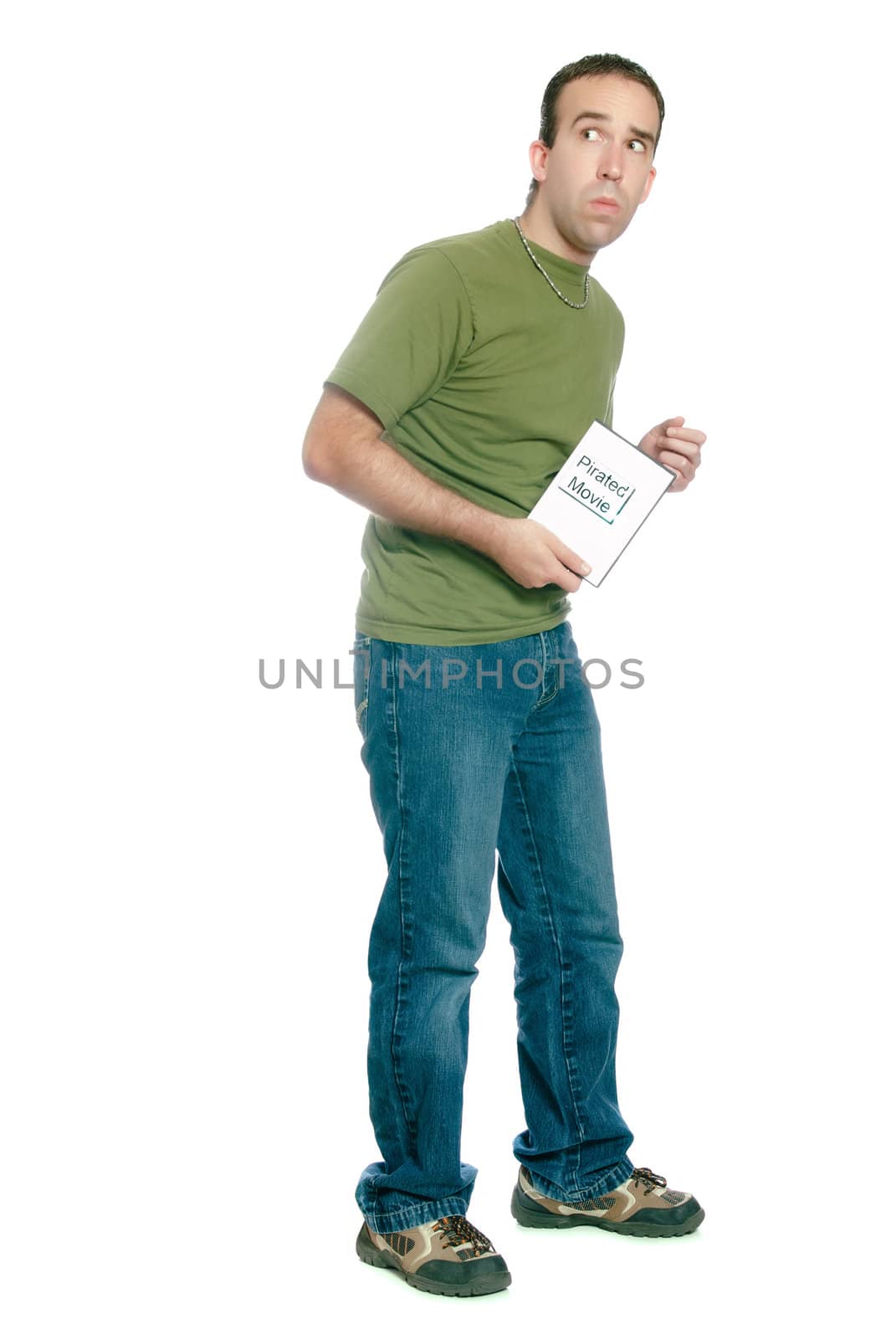 A young man sneaking away with an illegal movie download, isolated against a white background.