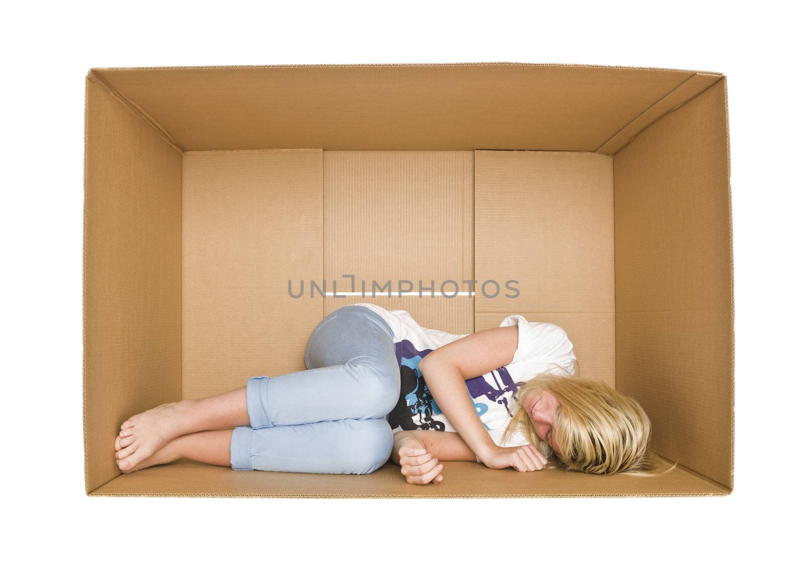 Woman sleeps in a cardboard box isolated on white background