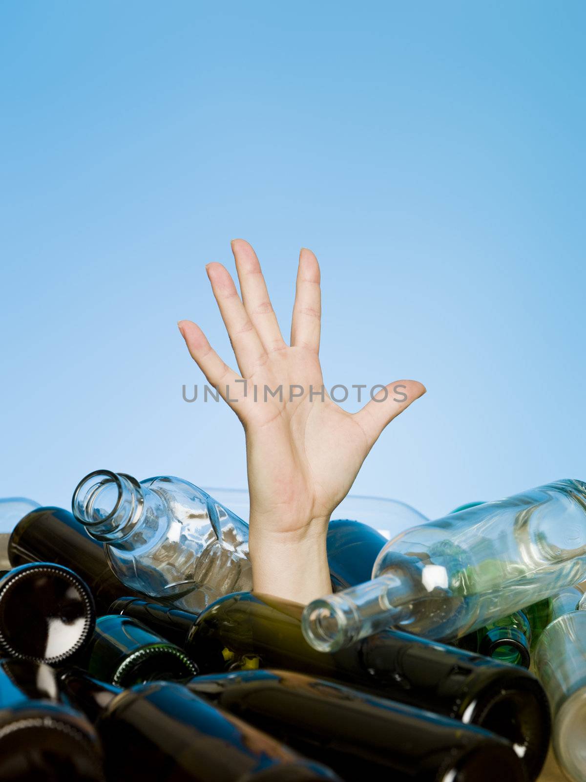 Human buried in a stack of glass bottles