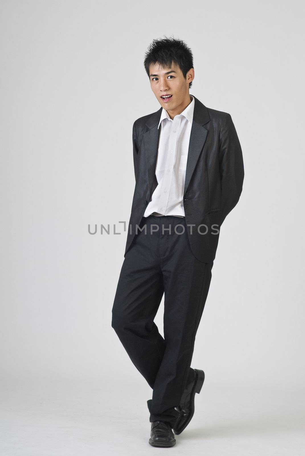 Full length portrait of young businessman standing.