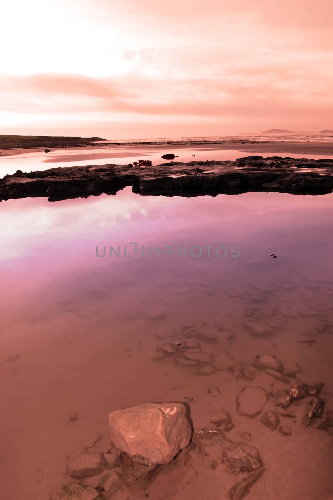 mud and rocks on beale beach co kerry ireland on a cold winters day
