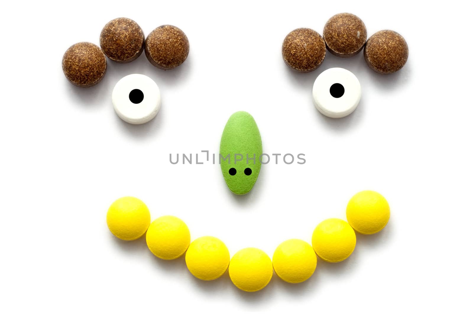 Smiling face concept of corolful medicine pills 
