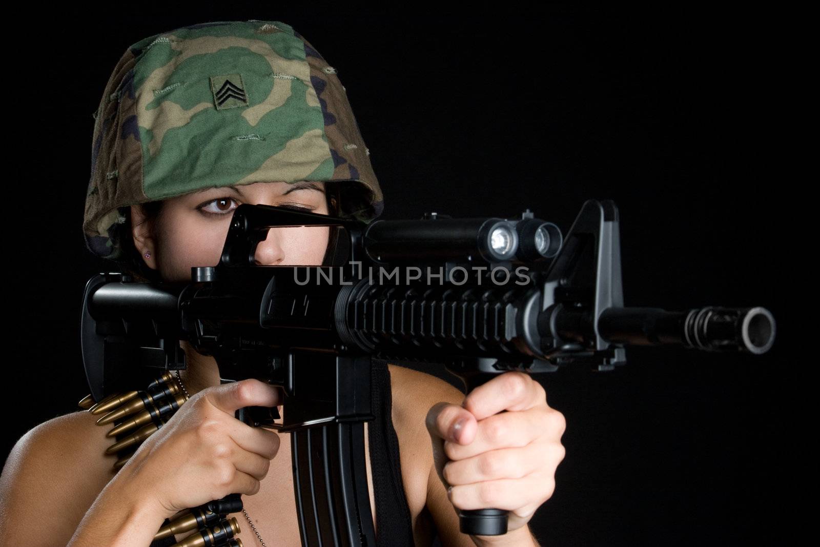 Military woman holding machine gun