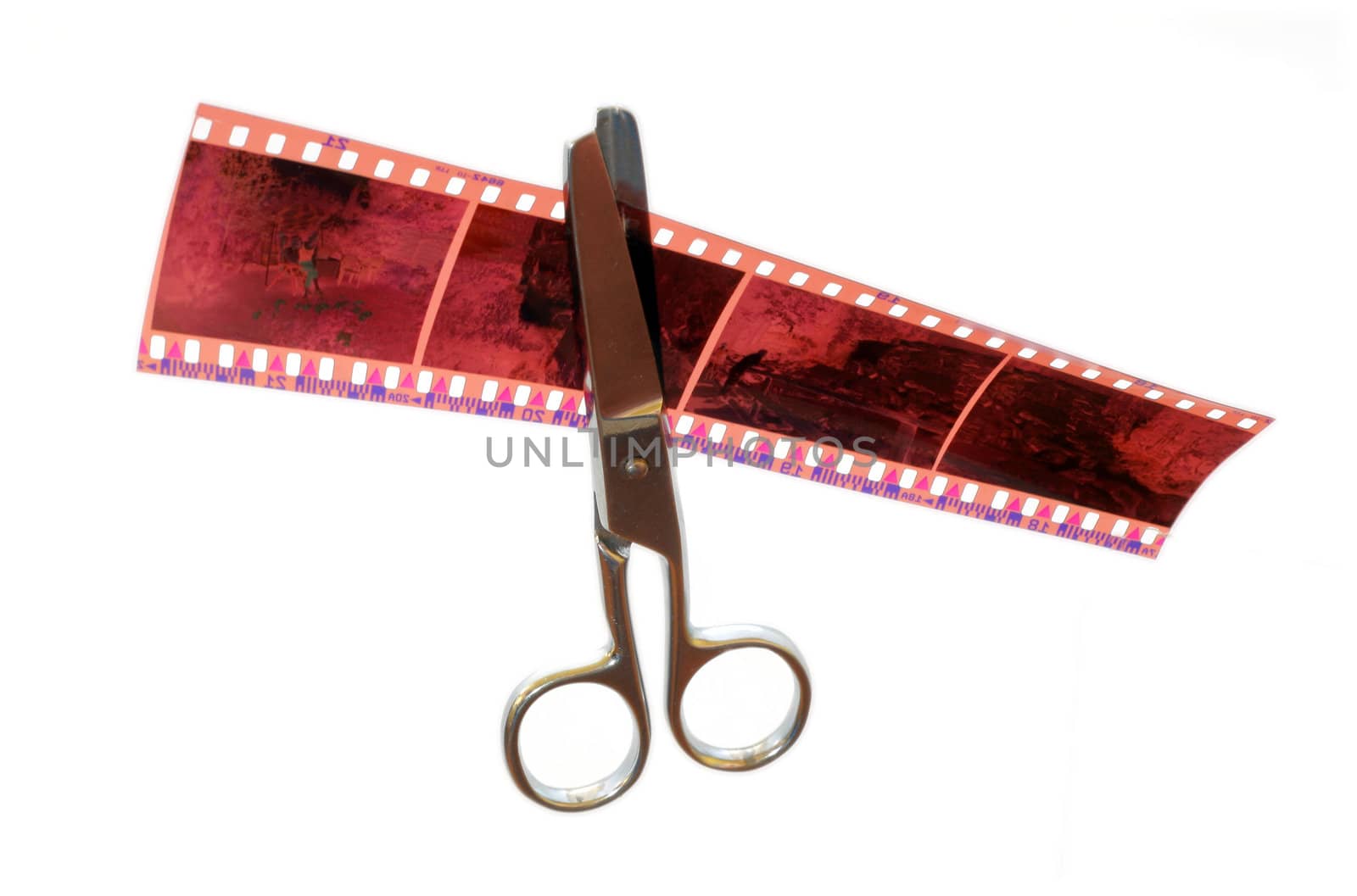 Metal scissors cuts the 35mm negative film stripe