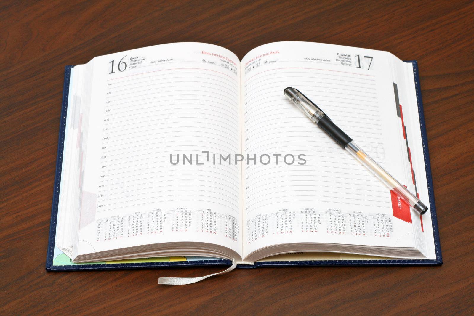 Diary and a pen on wooden table
