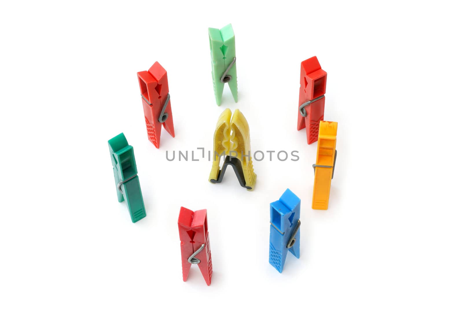 Colorful clothes pegs in a round row

