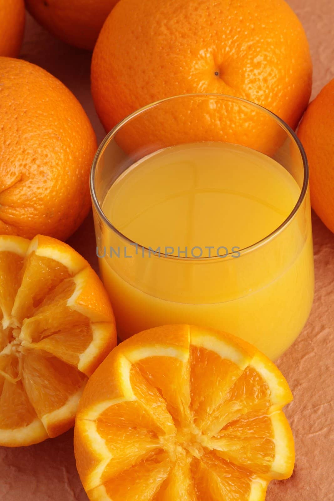glass of orange juice with fresh fruit beside