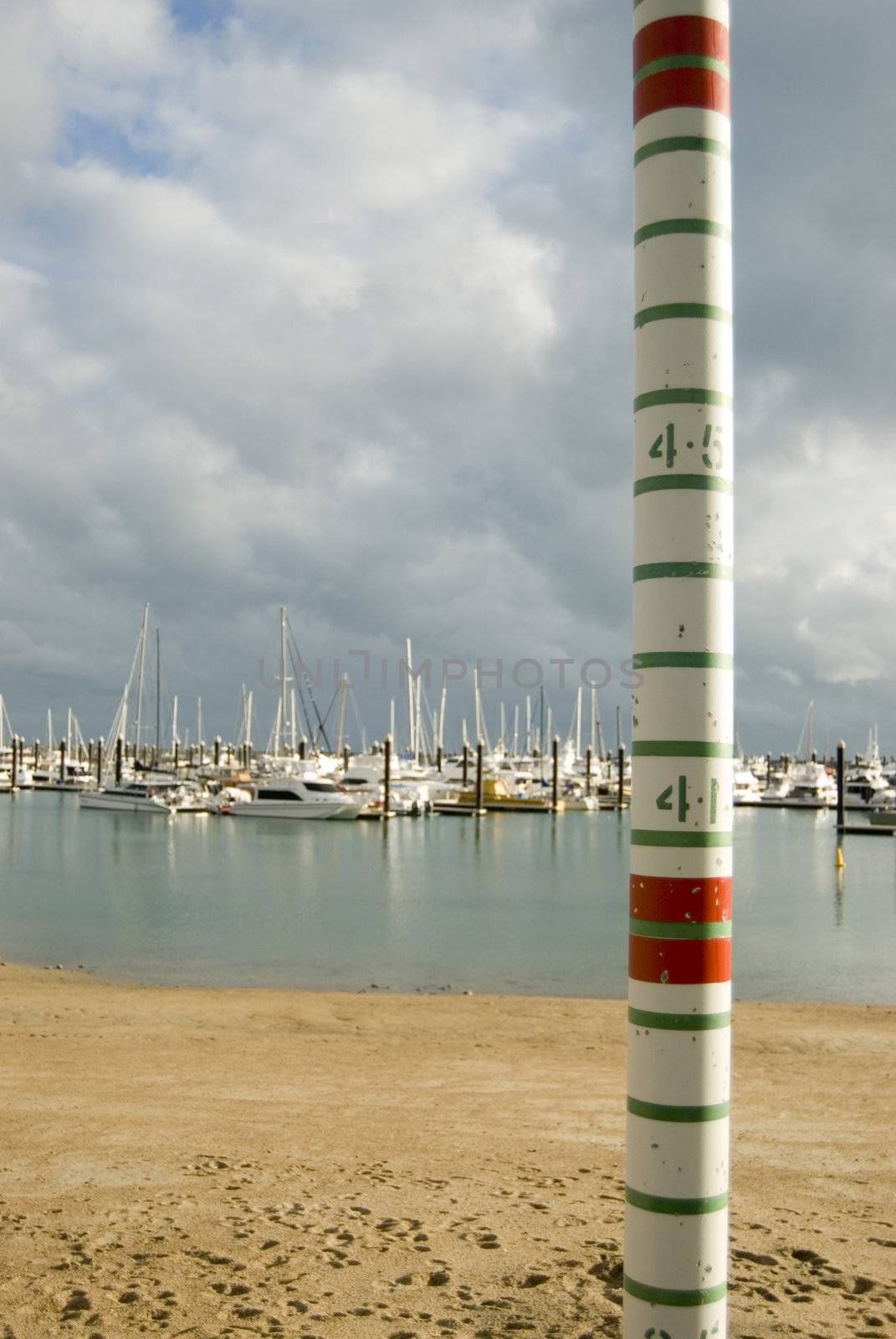 a graduated pole for measuring high tides in a marina
