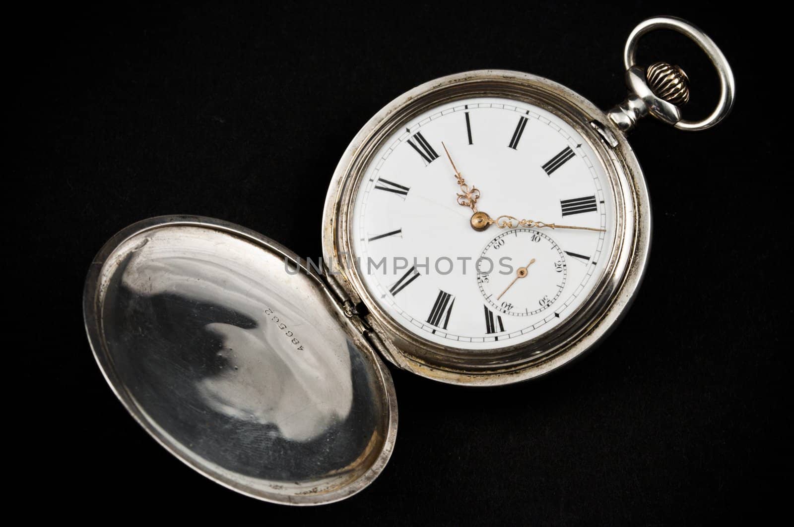 Elegant rusty pocket watch, isolated on black