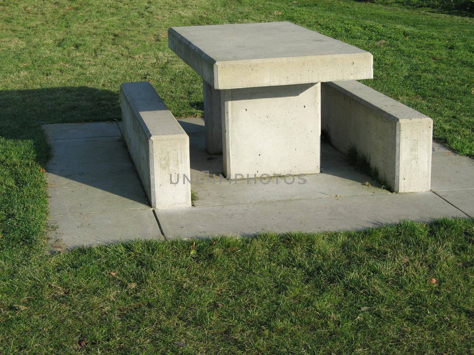 concrete table on the grass by mmm