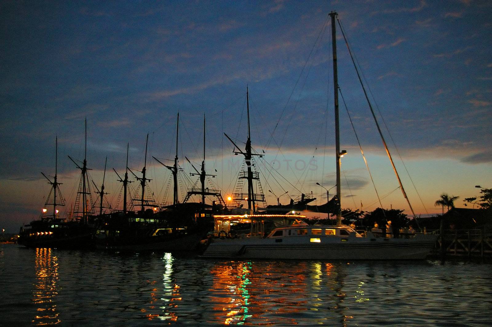 Private yachts anchored at sunset, Benoa harbour, Bali, Indonesia.
