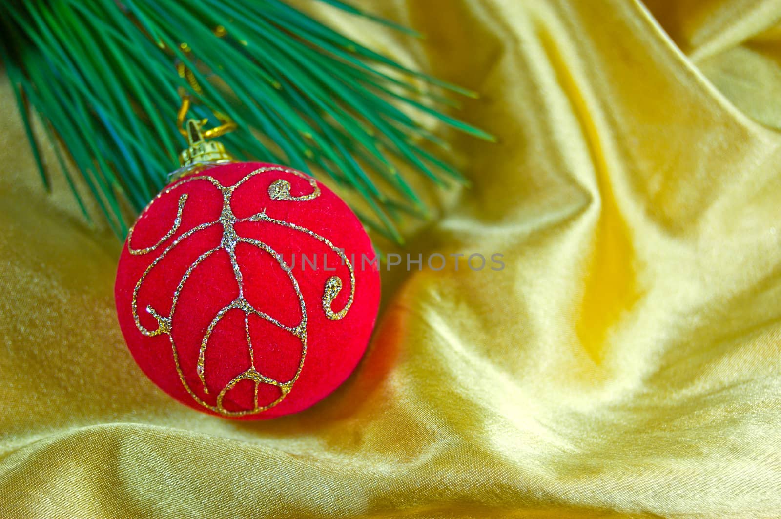 Christmas ornaments of red ball in silky golden fabric with tree