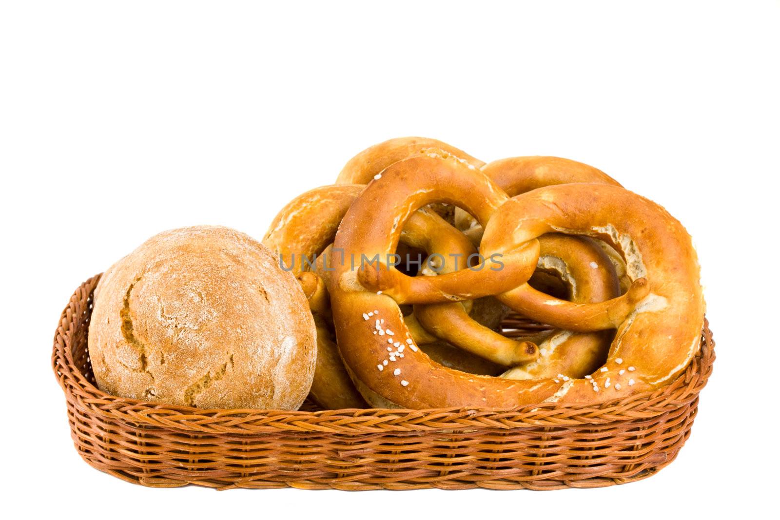 bread basket with pretzel isolated on white by bernjuer