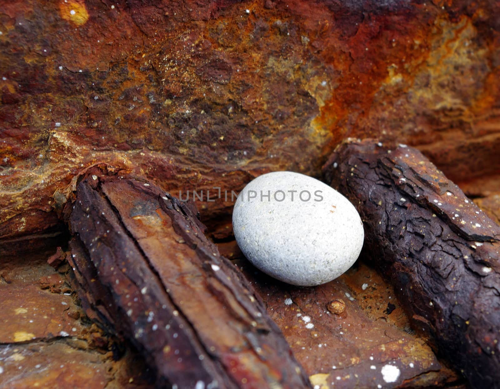 Old rusty iron lattice and the stone ground by the sea