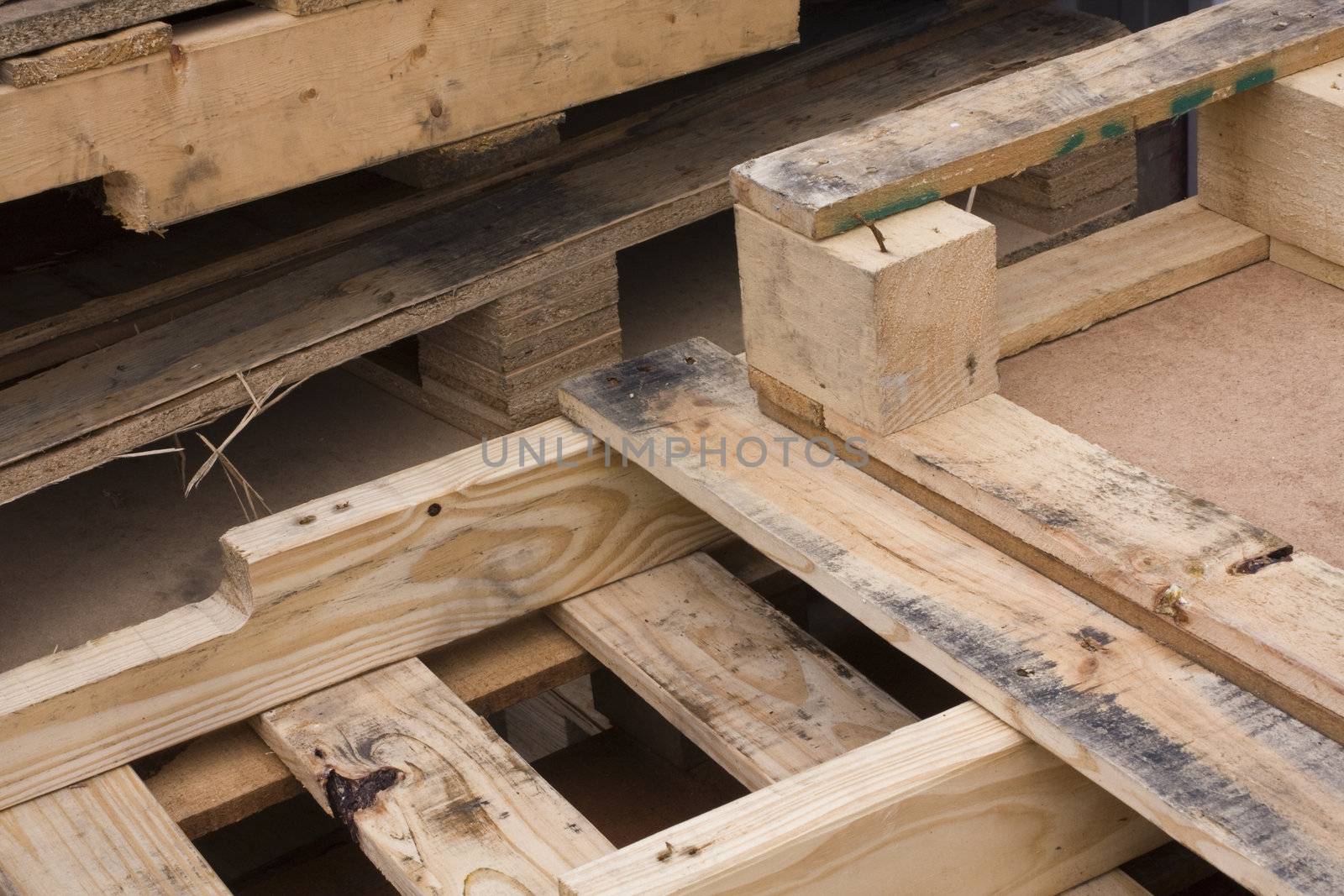 it is a shot of piles of wooden pallets 