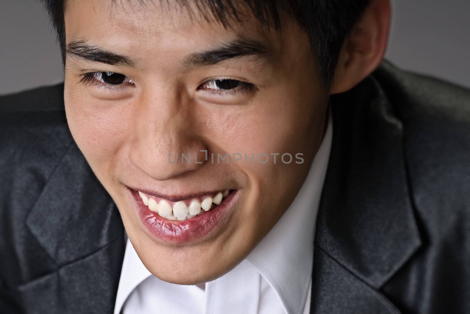 Smiling businessman face, closeup portrait with happy expression.