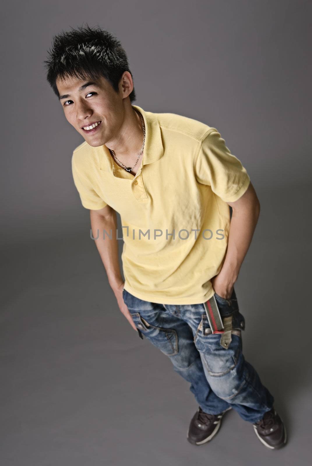 Full length portrait of smiling young man of Asian.