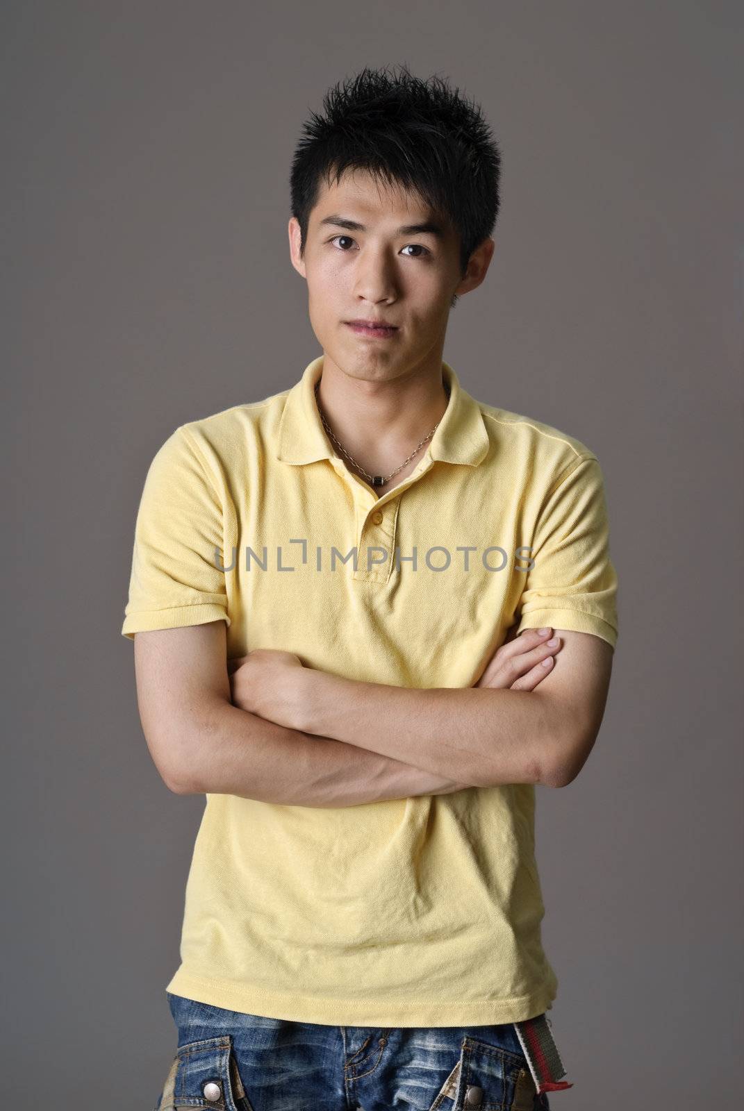 Portrait of Asian guy looking at camera.