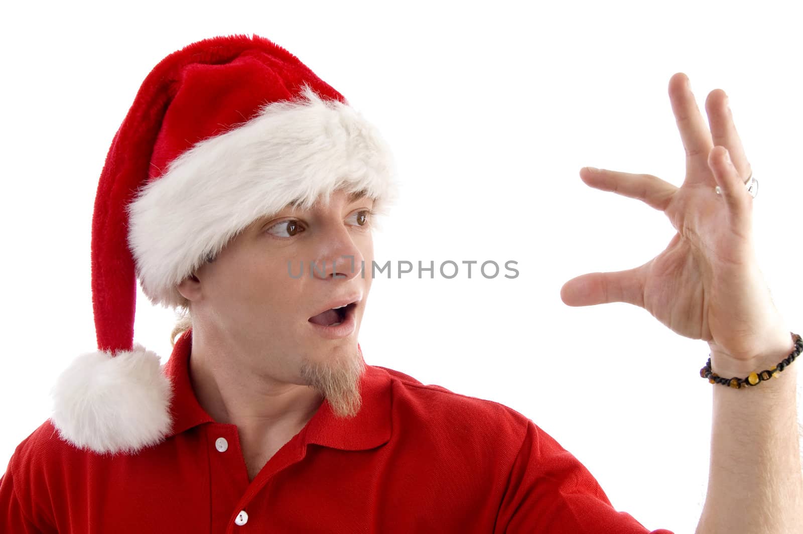 christmas hat wearing male looking at palm  by imagerymajestic
