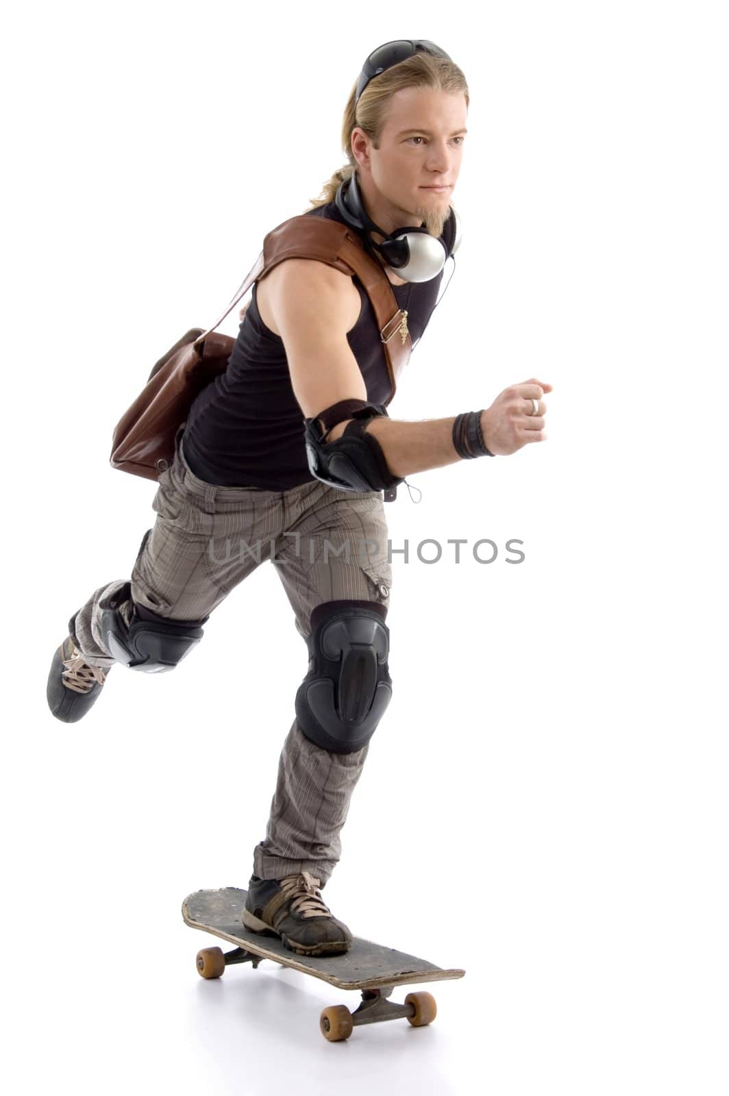 young man riding a skateboard against white background