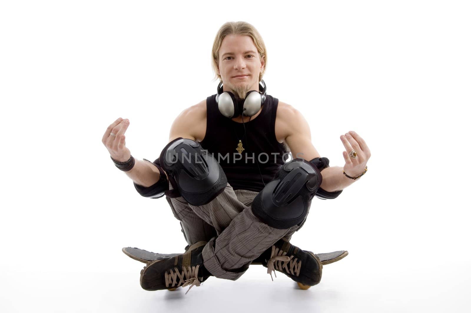 young man sitting on skateboard on an isolated white background