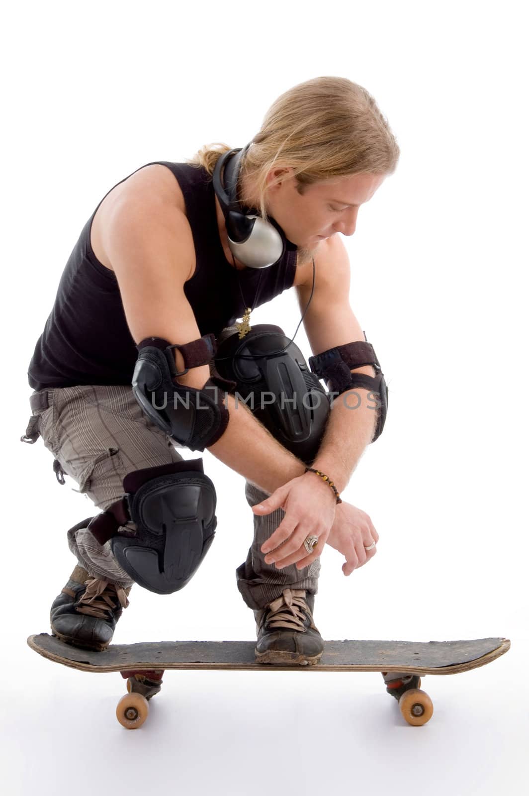 handsome american male sitting on skateboard on an isolated background