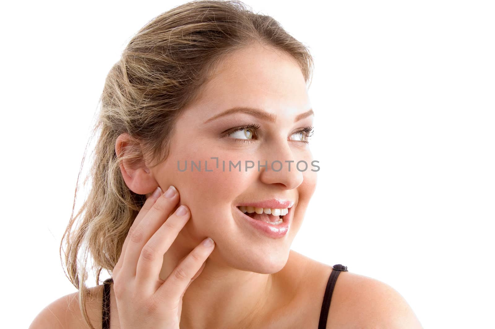 beautiful young woman smiling and looking sideways on an isolated white background