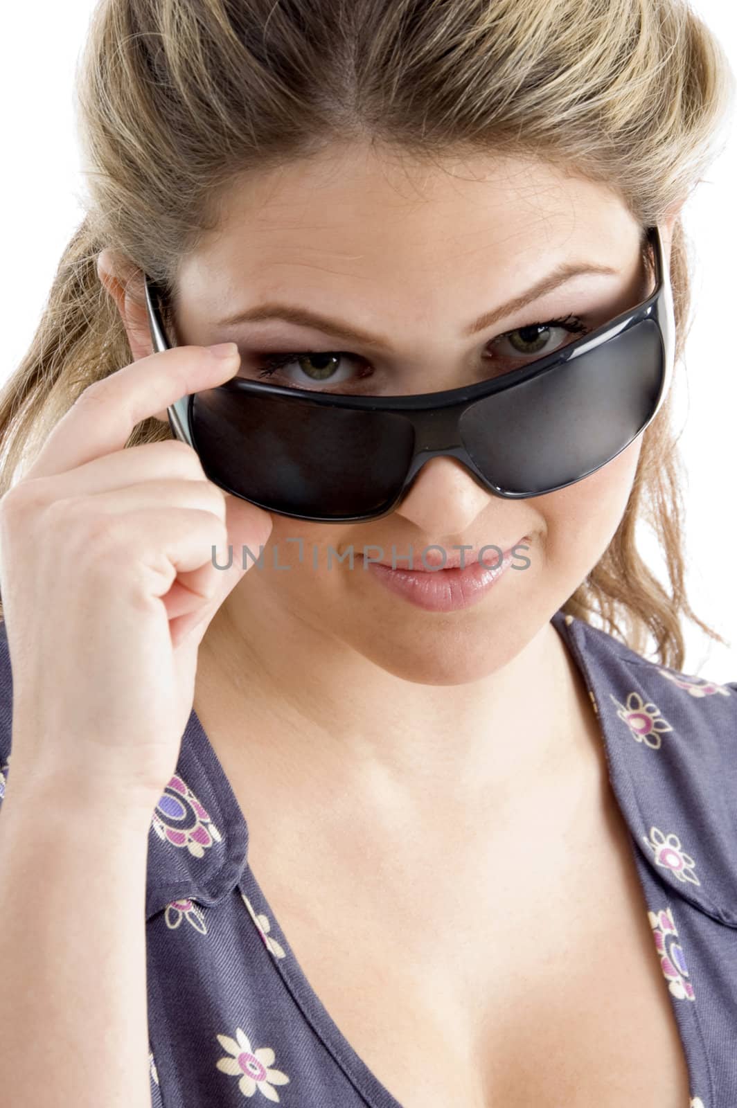 pretty model holding sunglasses on an isolated white background