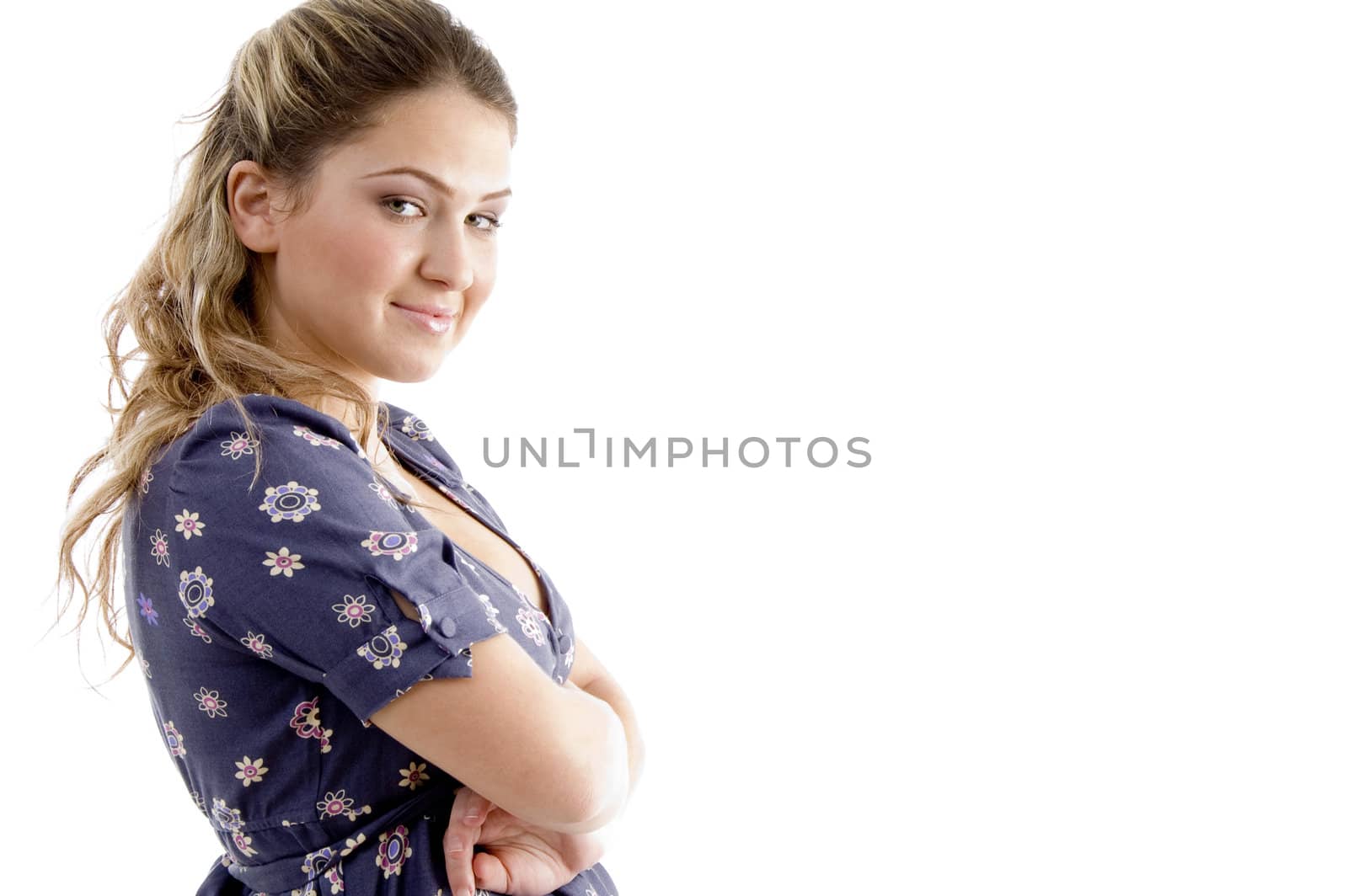 side view of smiling young girl with crossed arms on an isolated white background