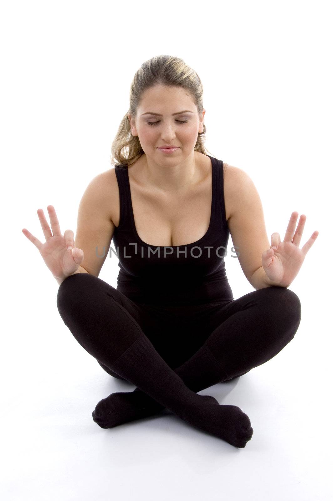 young girl doing yoga on an isolated background