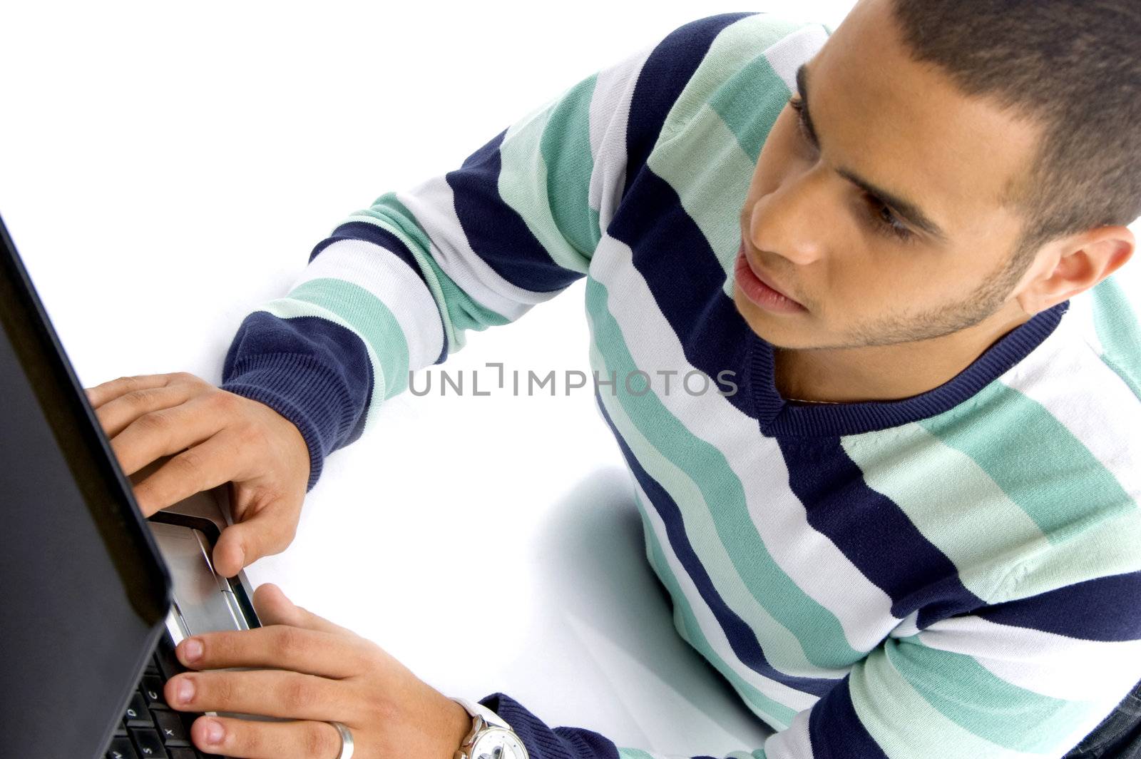 teenager guy working on laptop against white background