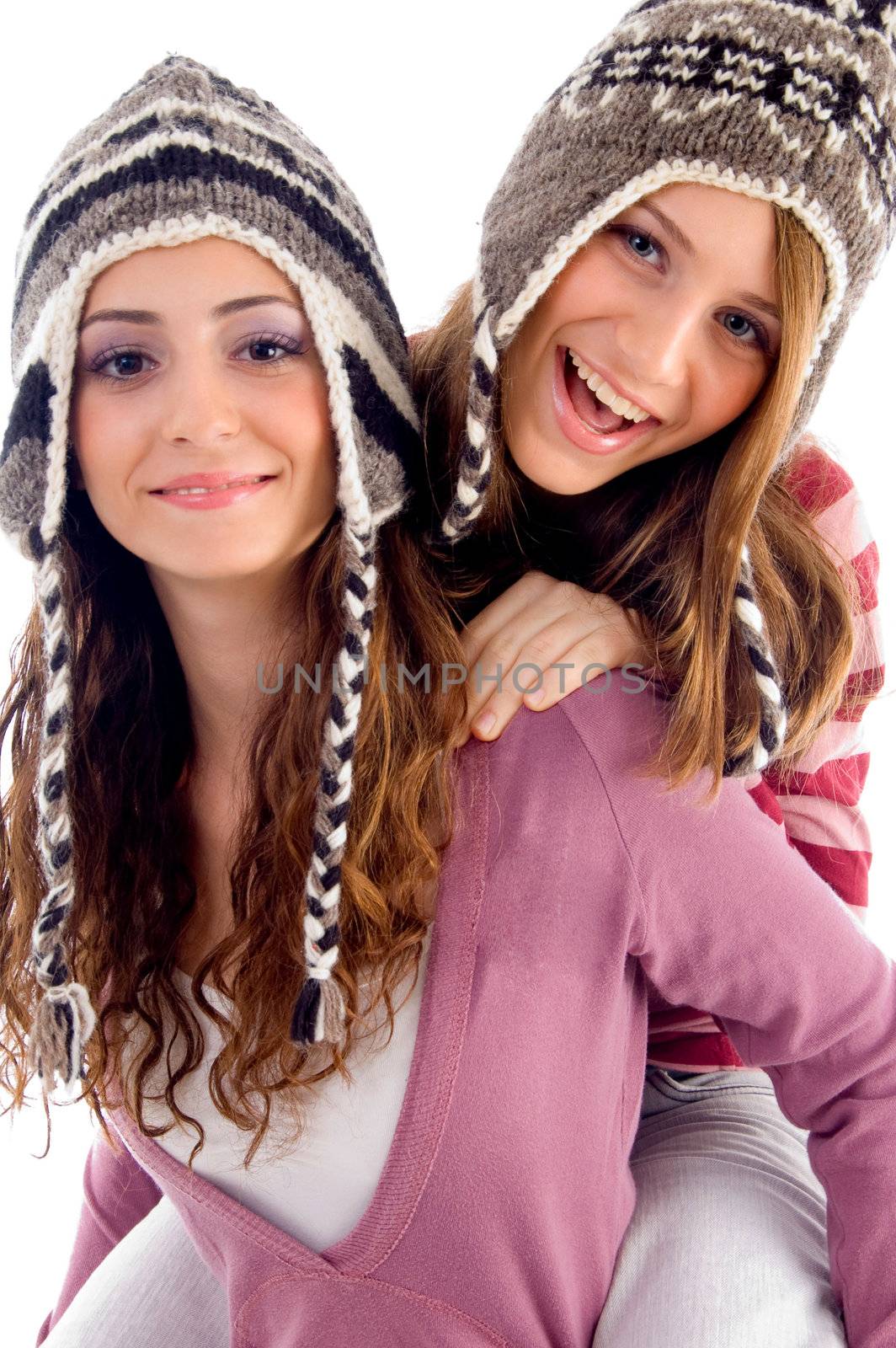 two girls showing happiness together on an isolated white background