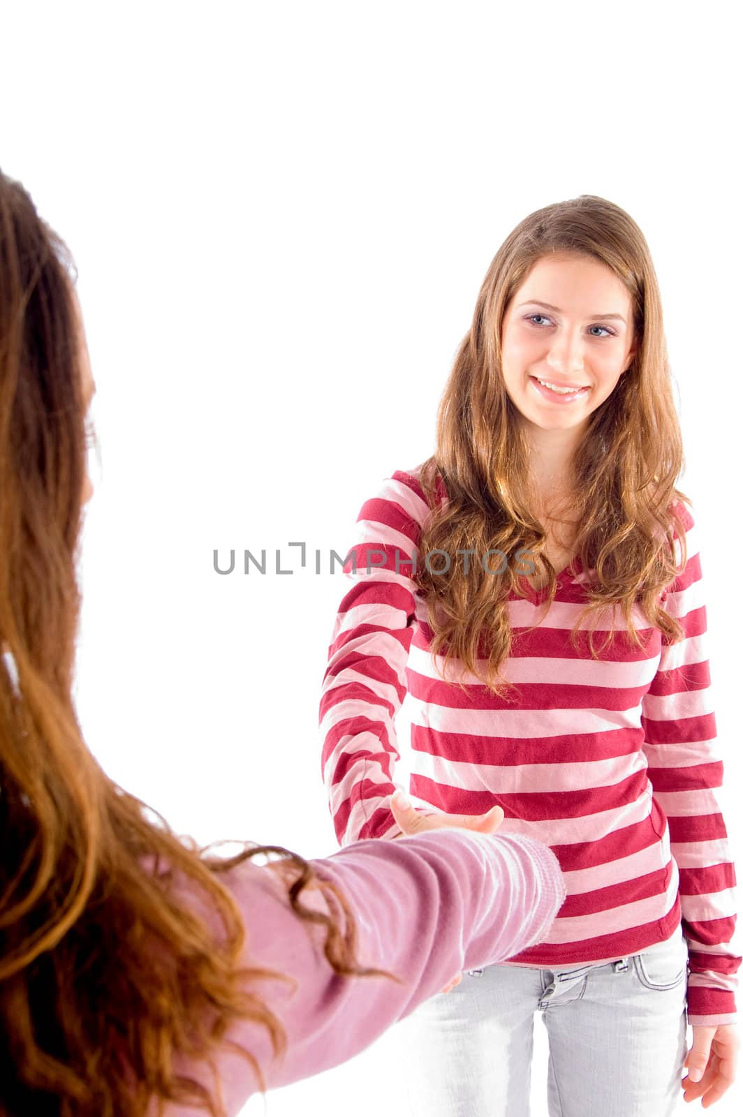friendly girls shaking hands on an isolated white background