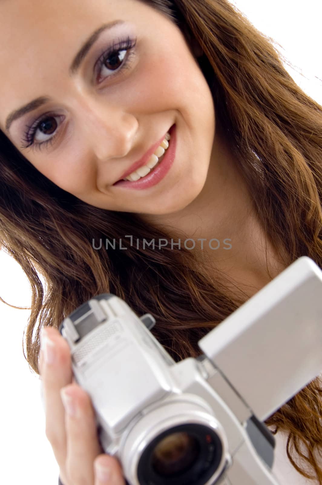 young female holding handy cam and looking at camera on an isolated white background