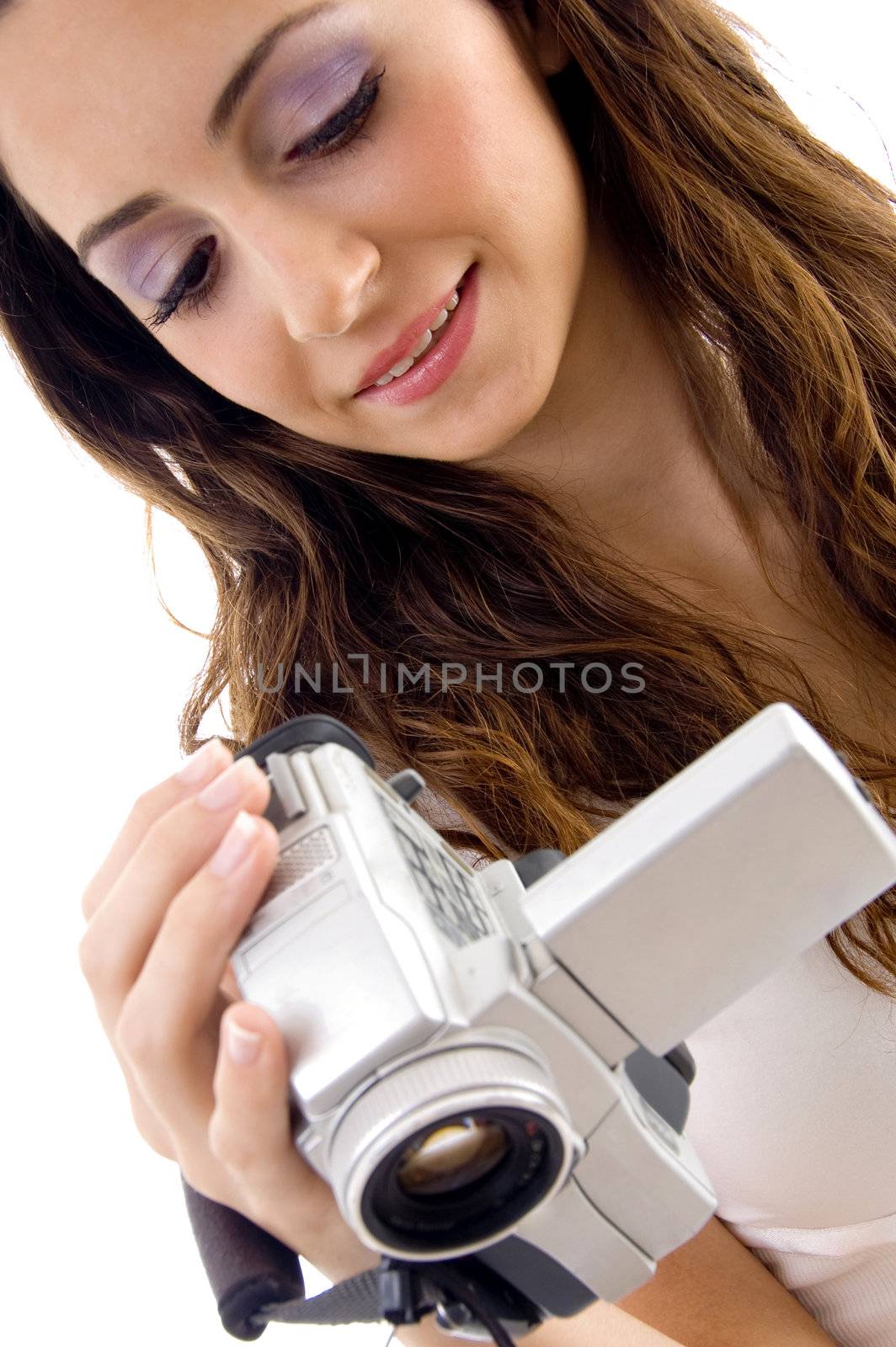 professional woman looking video into handy cam with white background