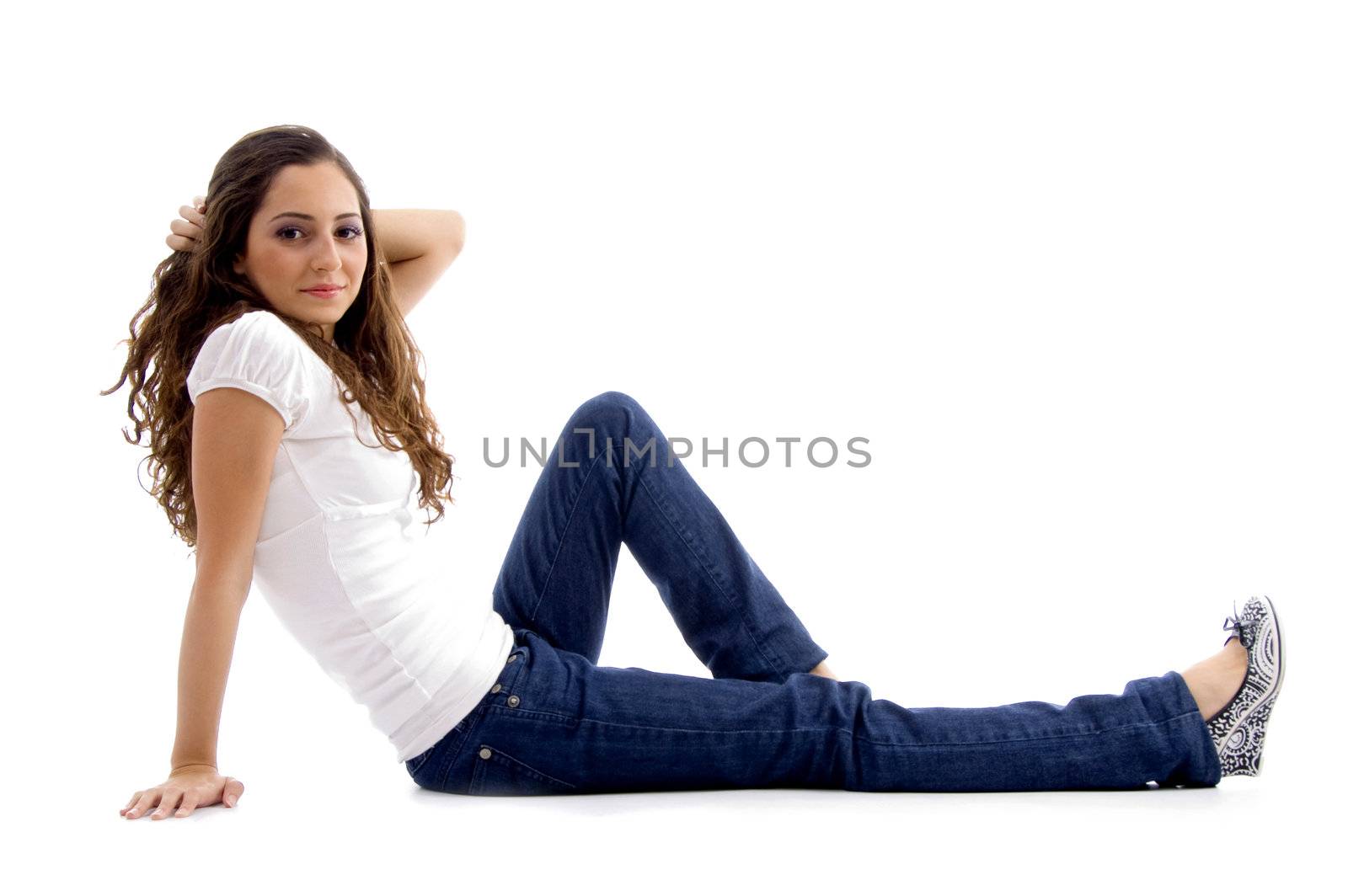 beautiful young model sitting on ground with white background