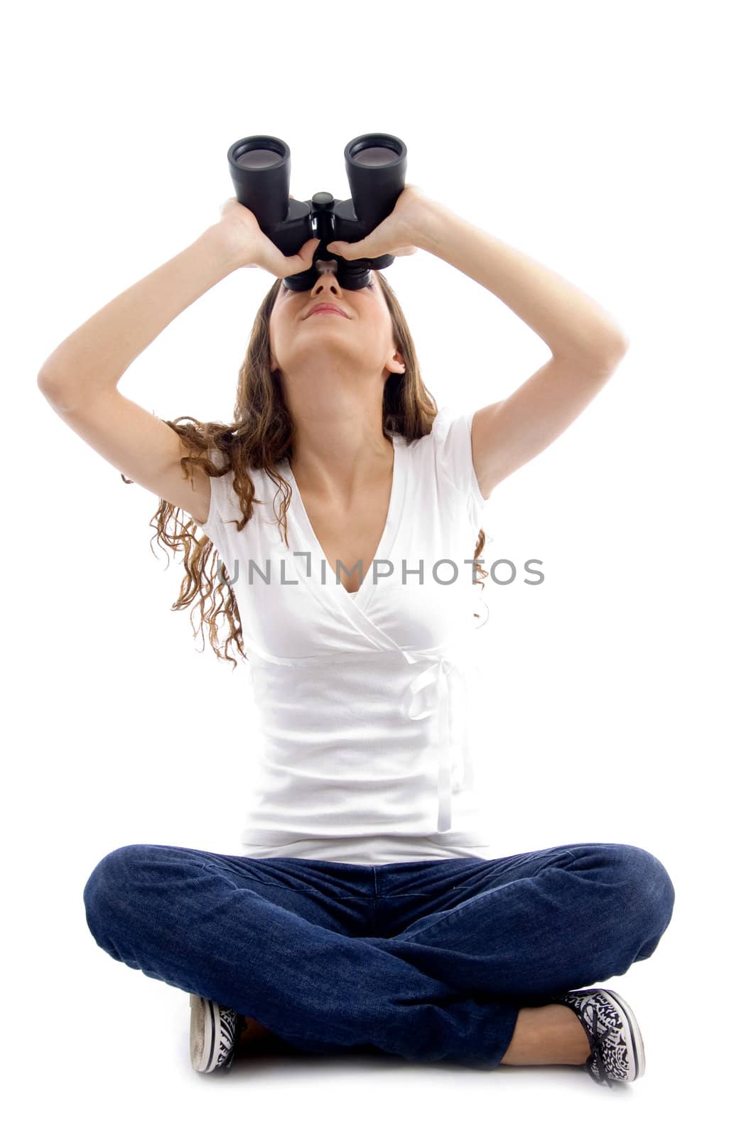 sitting girl looking through binocular against white background