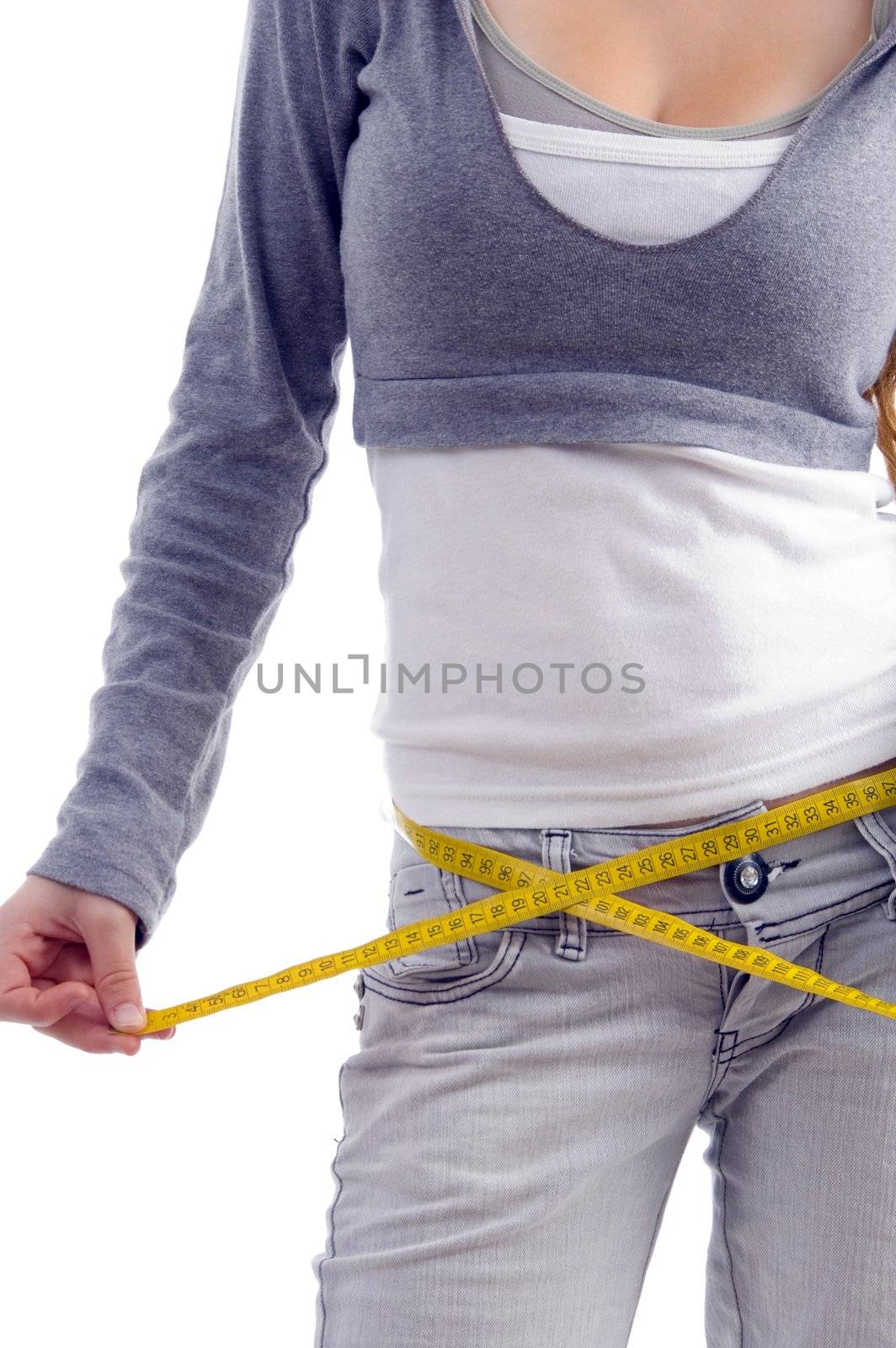 female measuring her waist with tape on an isolated white background