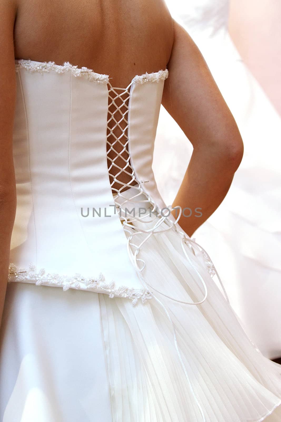 woman puts on beautiful white wedding dress