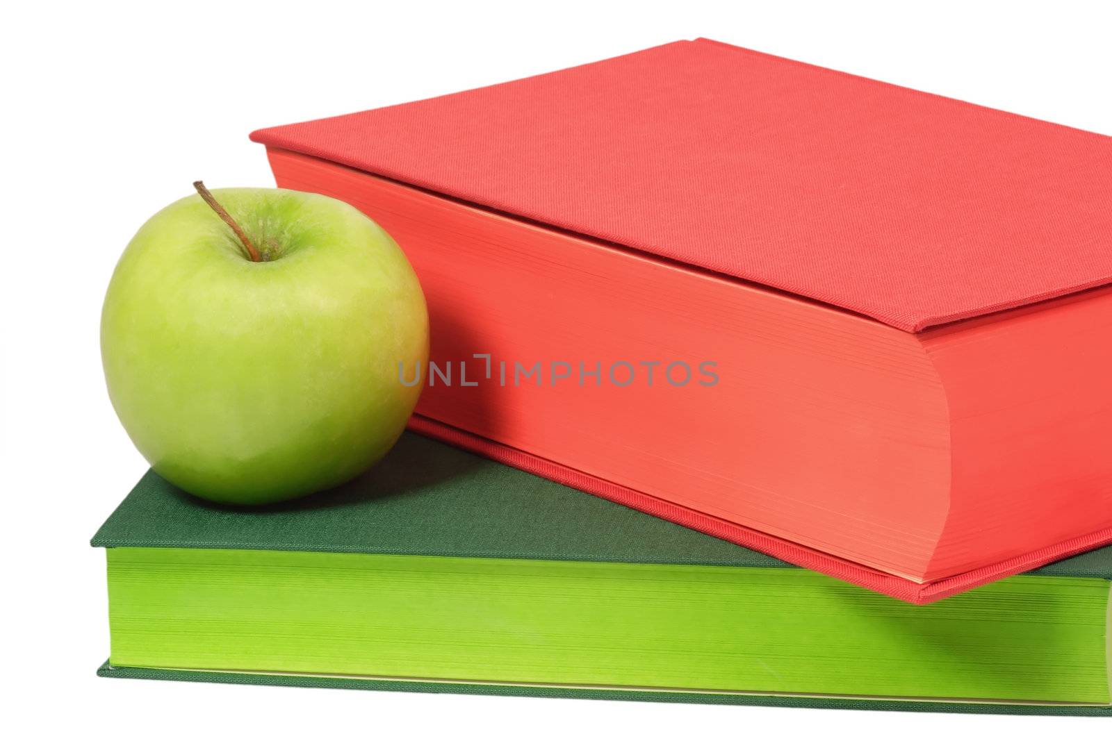 Books with green apple - isolated on white background
